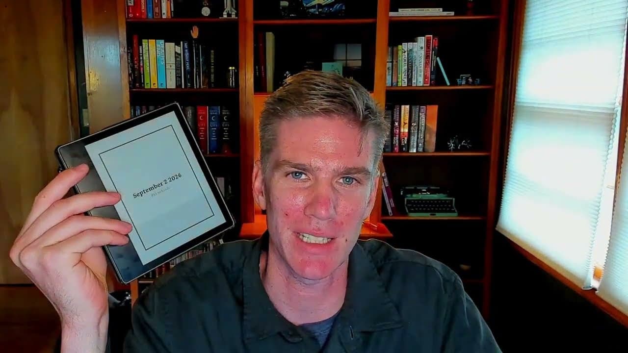 Marty holding a Kindle showing the daily digest cover for September 2 2026